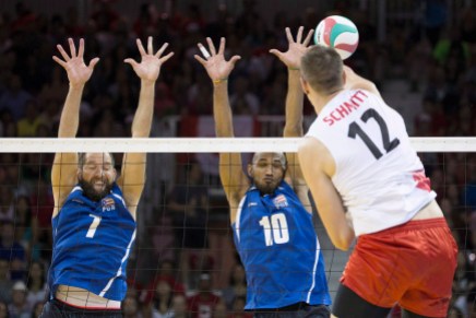 Enrique Escalante; Ezequiel Cruz; Gavin Schmitt Puerto Rico's Enrique Escalante (left) and Ezequiel Cruz (centre) jump totry and block a spike from Canada's Gavin Schmitt