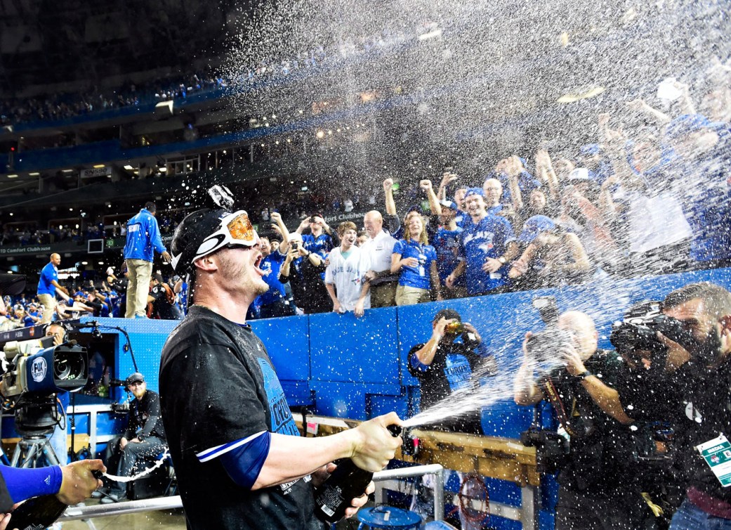 Josh Donaldson celebrates the Blue Jays' ALDS win over the Texas Rangers by dousing fans Champagne.