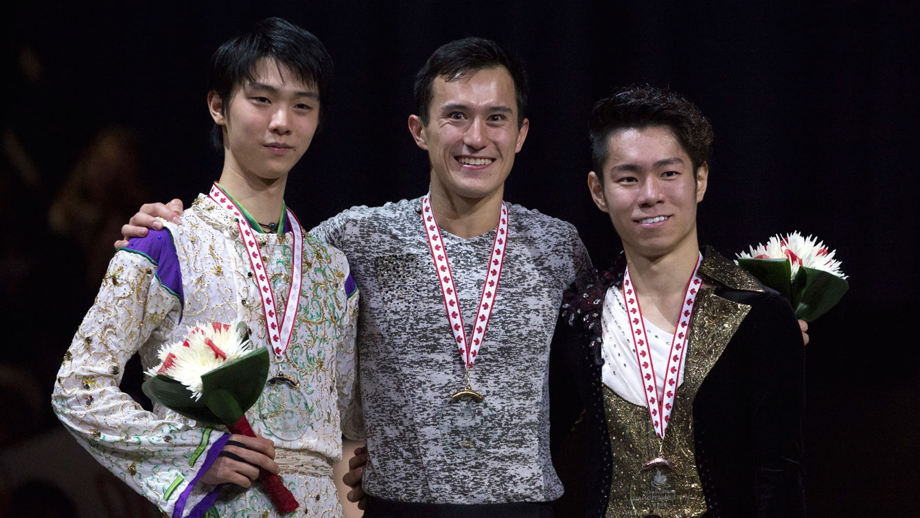 Patrick Chan (centre) receives his medal for winning Skate Canada International on October 31, 2015. 