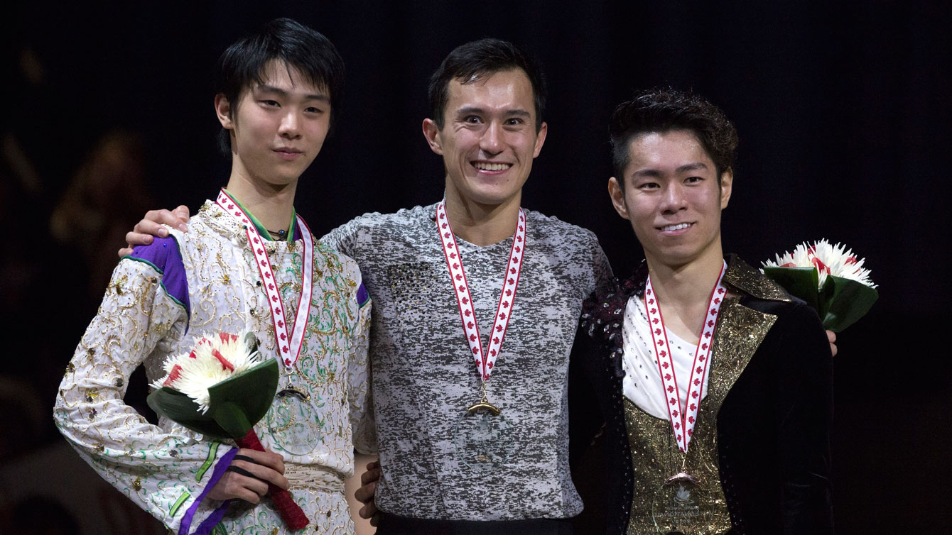 Patrick Chan (centre) receives his medal for winning Skate Canada International on October 31, 2015.
