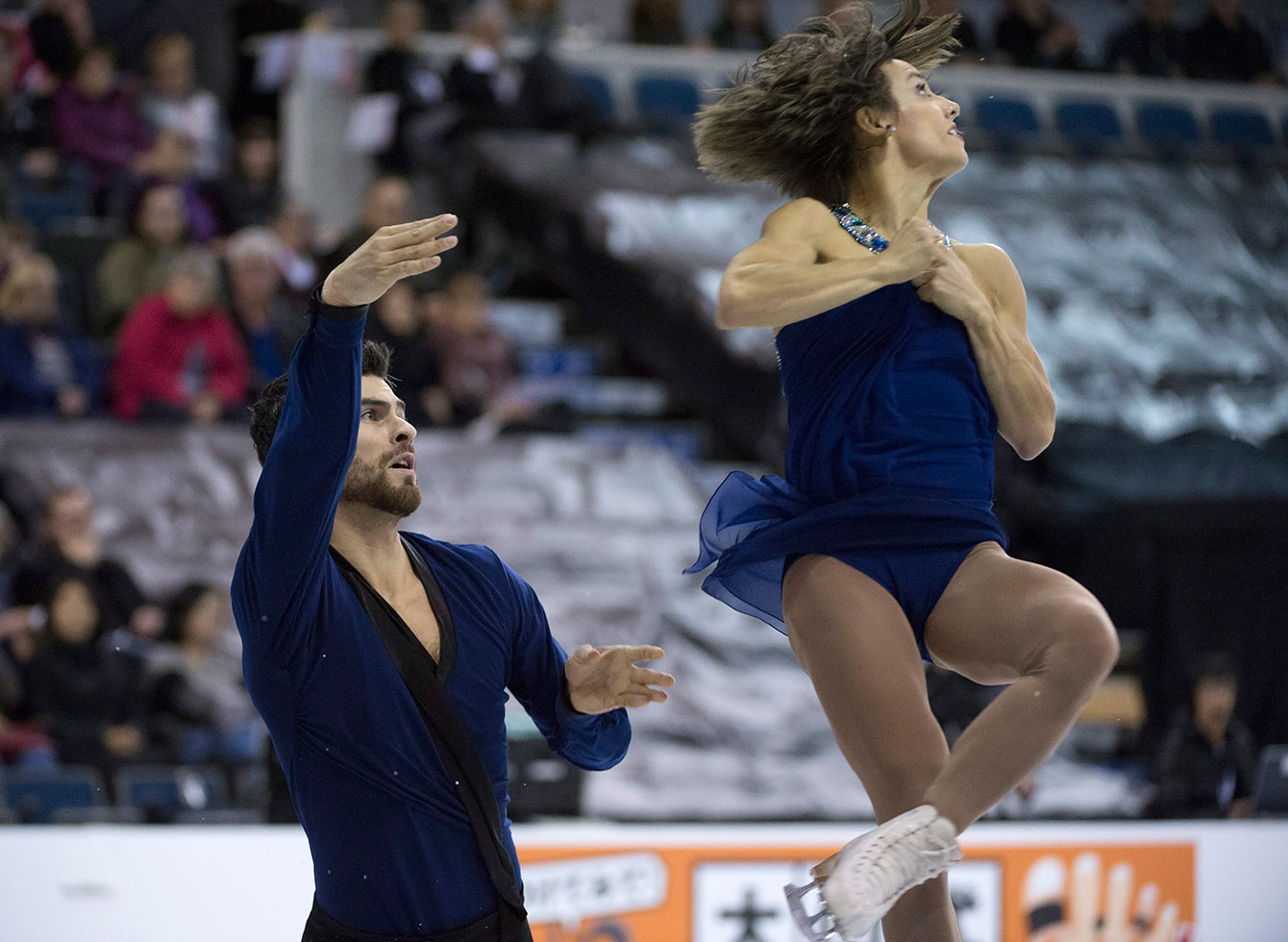 Meagan Duhamel and Eric Radford complete an element during their pairs free program at Skate Canada International on October 31, 2015. 