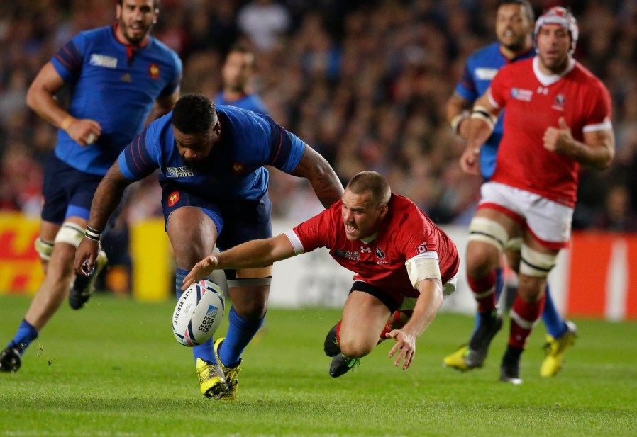 France's Mathieu Bastareaud, left, and Canada's Nick Blevins compete for the ball during the Rugby World Cup Pool D match between France and Canada at Milton Keynes, England, Thursday, Oct. 1, 2015. (AP Photo/Matt Dunham)