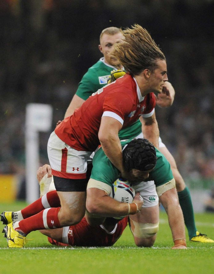 Ireland's Sean O'Brien is tackled by Canada's Jeff Hassler during their Rugby World Cup Pool D match at the Millennium Stadium, Cardiff, Wales, Saturday Sept. 19, 2015. (AP Photo/Rui Vieira)