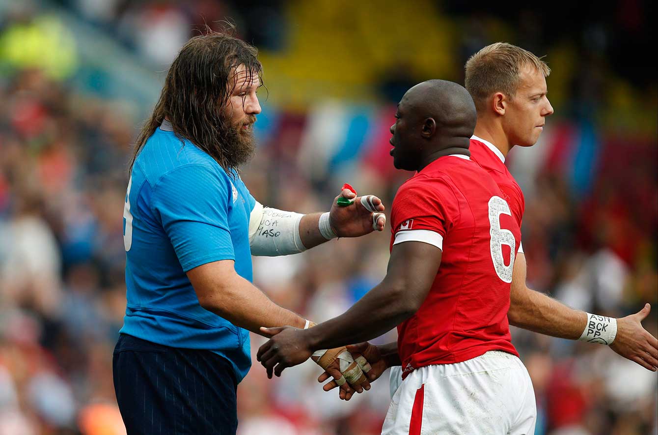 Italy's Martin Castrogiovanni, left, shakes hands with Canada's Nanyak Dala after their Rugby World Cup Pool D match at Elland Road, Leeds, England, Saturday, Sept. 26, 2015. Italy won the match 23-18. (AP Photo/Alastair Grant)
