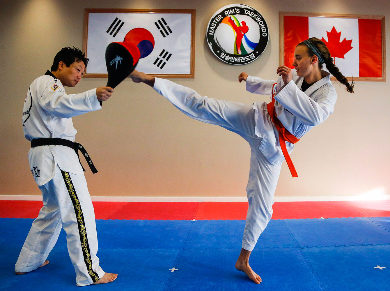 Luge athlete Kim McRae (right) works on bettering her body movement through taekwondo in Calgary. 