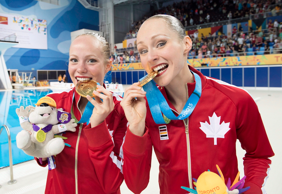 Canadians Jacqueline Simoneau and Karine Thomas (right) show off their Gold medals after winning the Synchronized Swimming Duet at the 2015 Pan Am Games in Toronto on Saturday, July 11, 2015. 