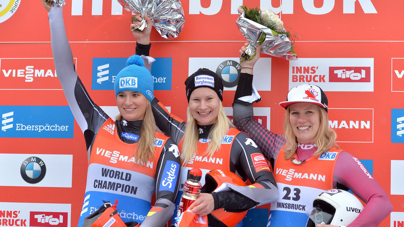 Alex Gough (right) stands on the bronze position of the podium in Igls, Austria near Innsbruck, at the FIL Luge World Cup on November 28, 2015. 