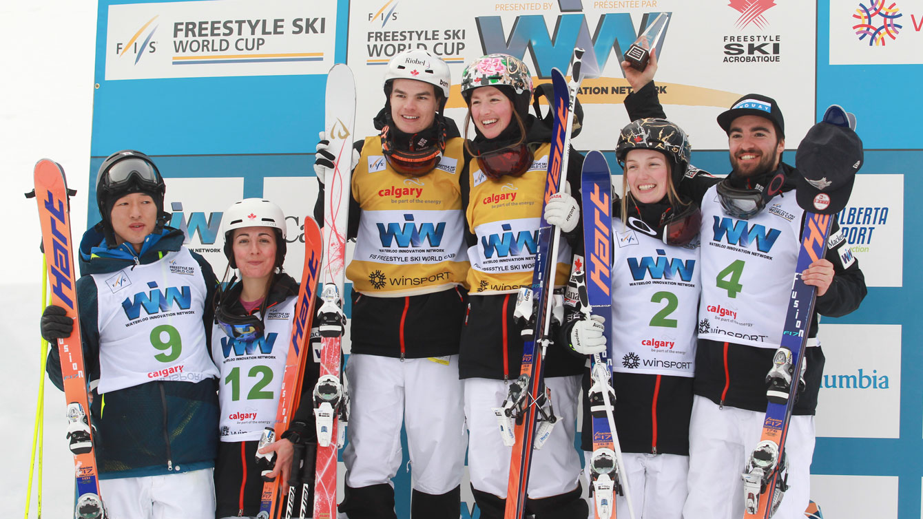 Japan's Sho Endo (far left) joins five Canadians - (L-R) Andi Naude, Mikael Kingsbury, Chloe Dufour Lapointe, Justine Dufour-Lapointe and Phil Marquis - on the moguls World Cup podium in Calgary on January 30, 2016 (Mike Ridewood/CFSA).