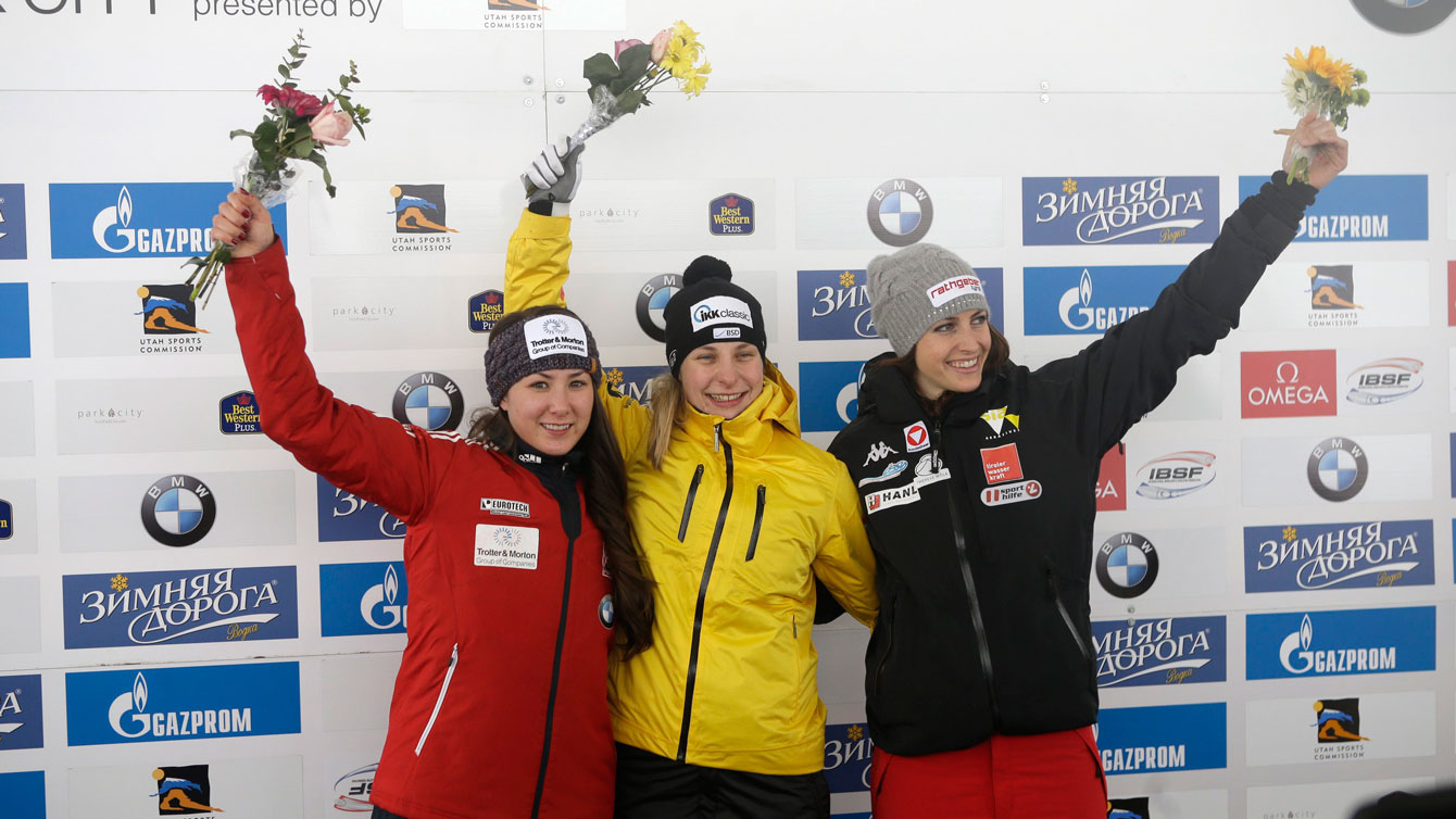 Jane Channell (left) celebrates her second place World Cup finish in women's skeleton during the flower ceremony at Park City, Utah on January 16, 2016. 