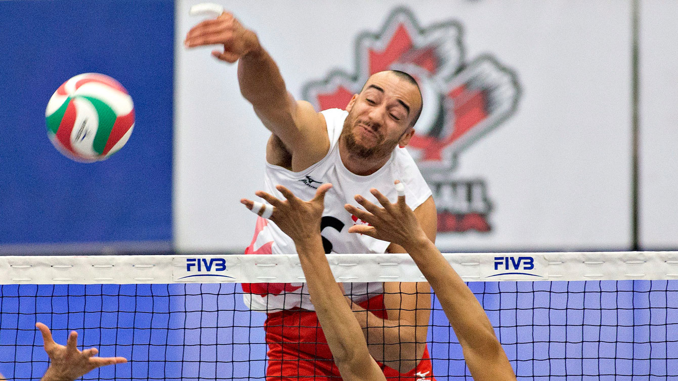 Justin Duff smashes the ball against Puerto Rico during regional Olympic qualifiers in Edmonton on January 9, 2016. 