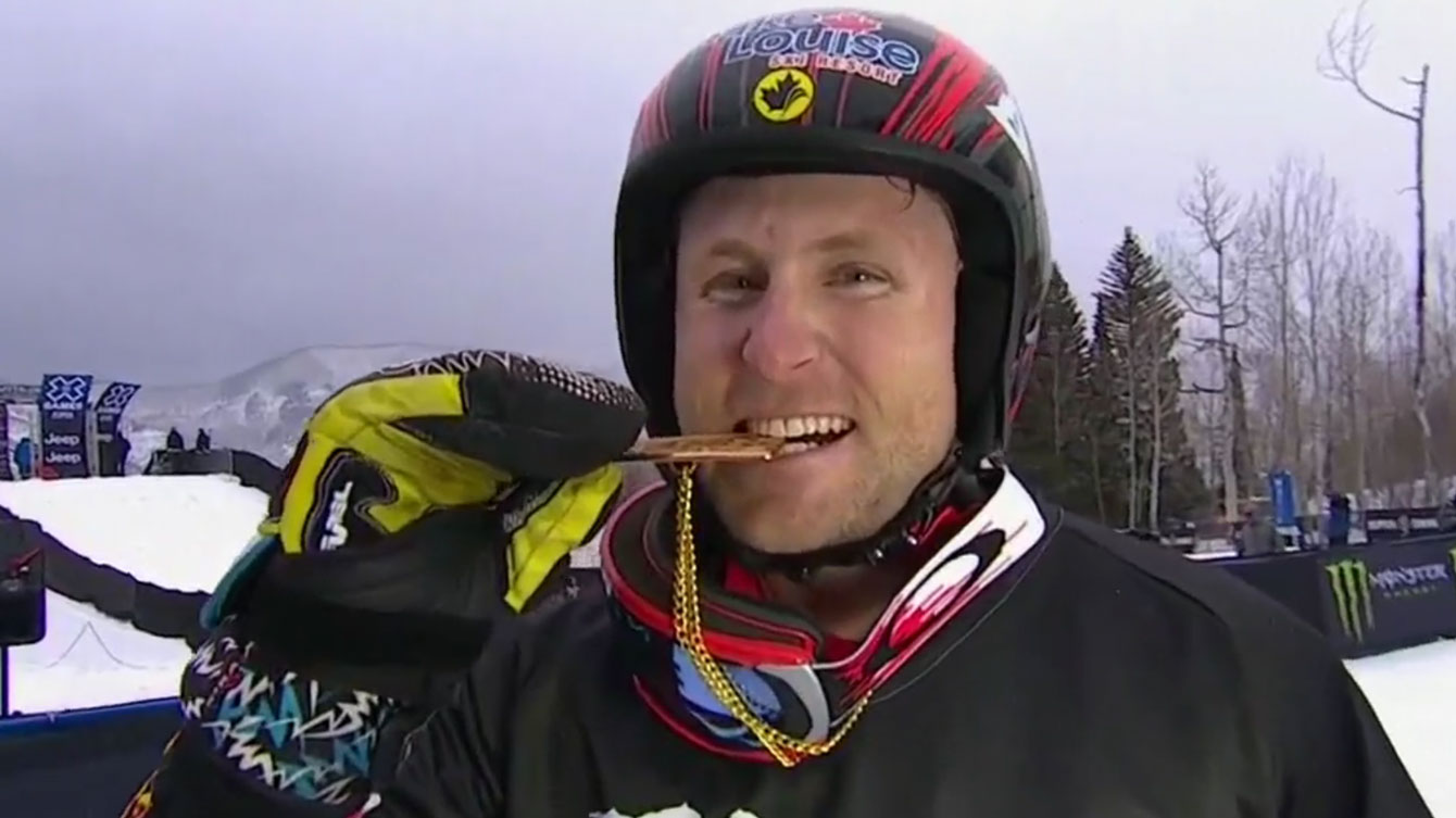 Brady Leman bites the X Games medal after winning skier x (ski cross) gold on January 30, 2016.