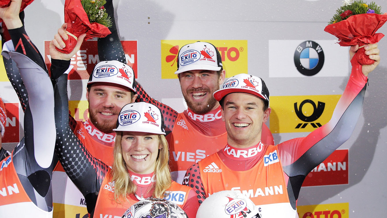 Canadians Justin Snith, Alex Gough, Tristan Walker and Mitchel Malyk celebrate team relay bronze at FIL World Championships on January 31, 2016.