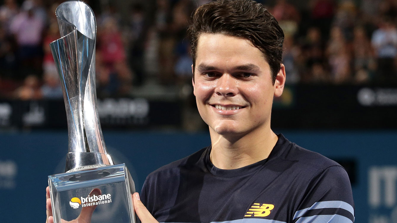 Milos Raonic holds aloft the Brisbane International trophy, his eighth ATP World Tour title won on January 10, 2016 by beating Roger Federer 6-4, 6-4.