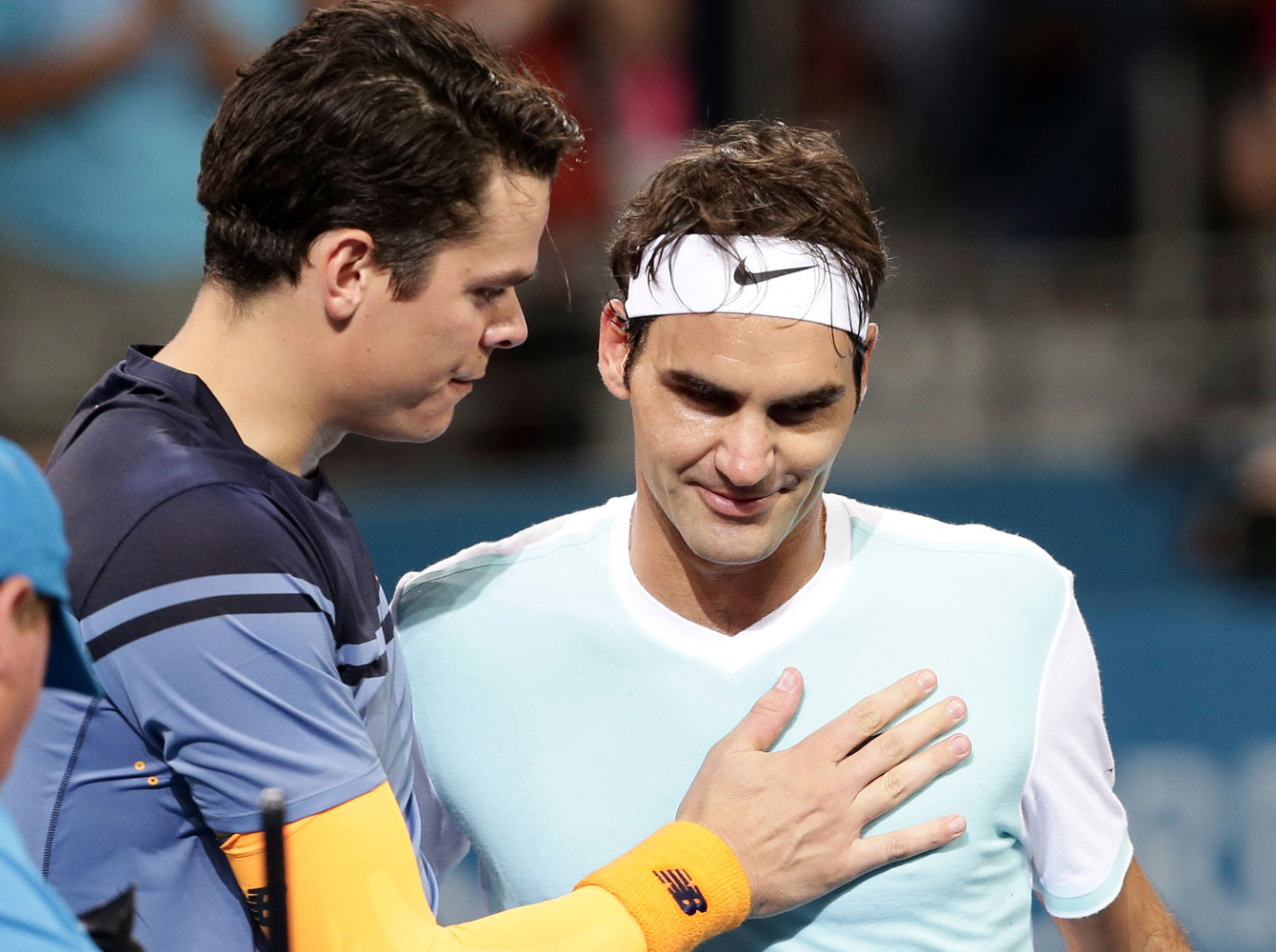 Milos Raonic consoles Roger Federer following the Brisbane International final where the Canadian prevailed on January 10, 2016.