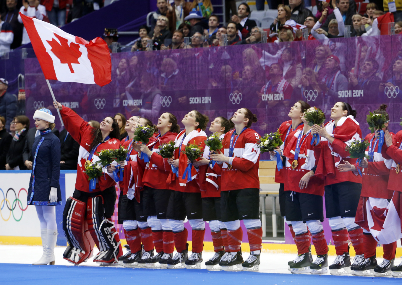 Team Canada sings the Canadian national anthem after receiving their gold medals after beating the USA 3-2 in overtime of the women's gold medal ice hockey game at the 2014 Winter Olympics, Friday, Feb. 21, 2014, in Sochi, Russia. (AP Photo/Mark Humphrey)