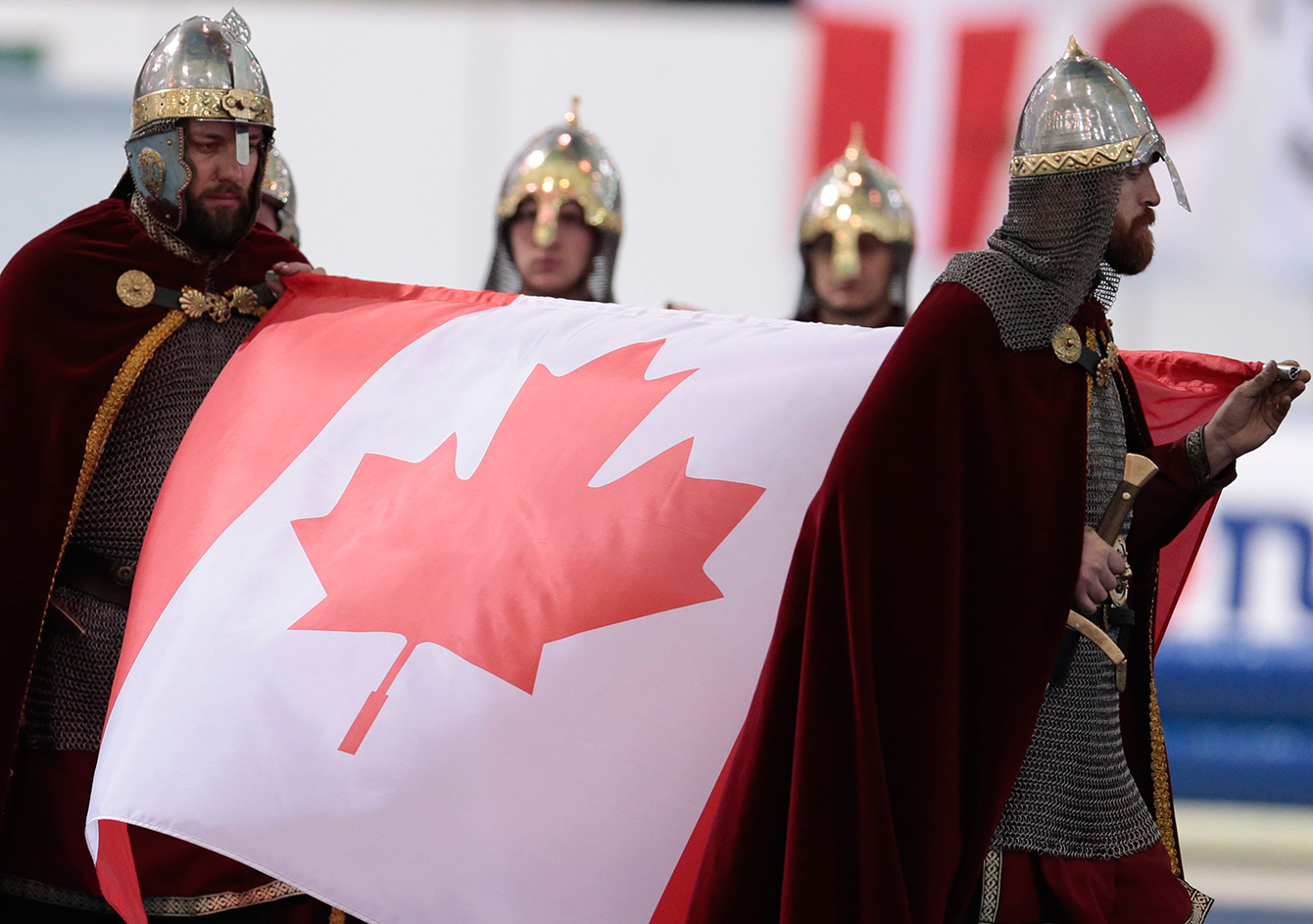 Performers, dressed as ancient Russian warriors, carry Canadian flag for the victory ceremony of the women's mass start race of the speed skating single distance World Championships in Kolomna, Russia, on February 14, 2016. (AP Photo/Ivan Sekretarev)