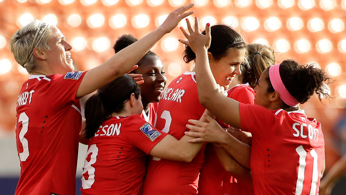 Christine Sinclair (second from right) is congratulated by teammates after scoring her 159th career international goal on February 14, 2016. 