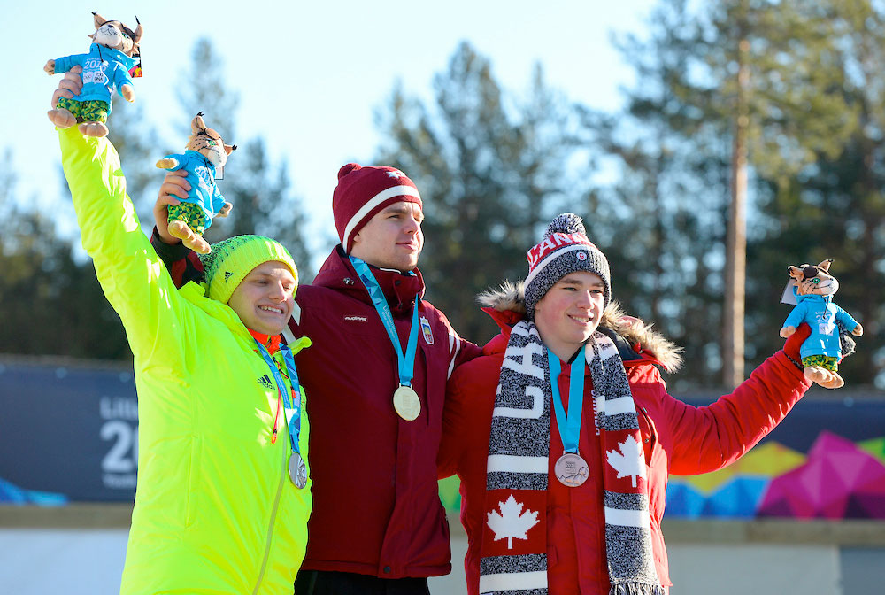 Eric Watts celebrates his bronze medal on the luge singles podium at the Youth Olympic Games in Lillehammer, Norway on February 13, 2016.