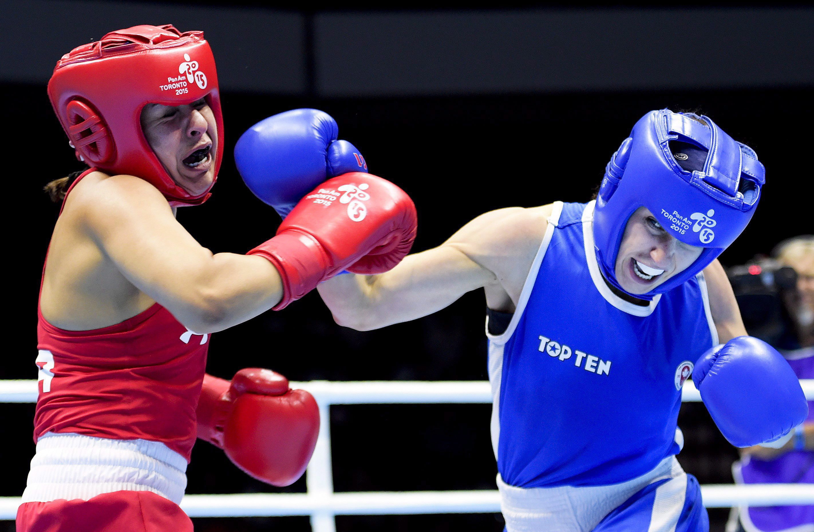 Mandy Bujold, right, of Canada, competes against Marlen Esparza, of the United States, in the women's 48-51kg flyweight gold medal boxing final during the Pan American Games in Oshawa, Ontario, on Thursday, July 25, 2015. Bujold won gold. THE CANADIAN PRESS/Nathan Denette