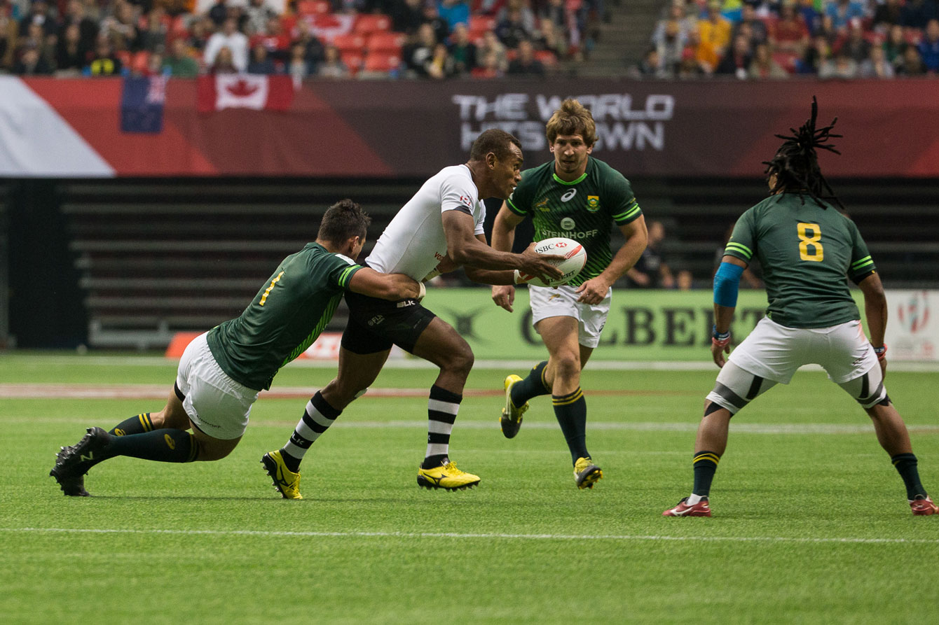 Three Springbok players close in on a member of the Fijian squad in the cup semifinals. South Africa downed Fiji 31-19 to advance to the cup final (Photo: Derek Stevens via Rugby Canada).