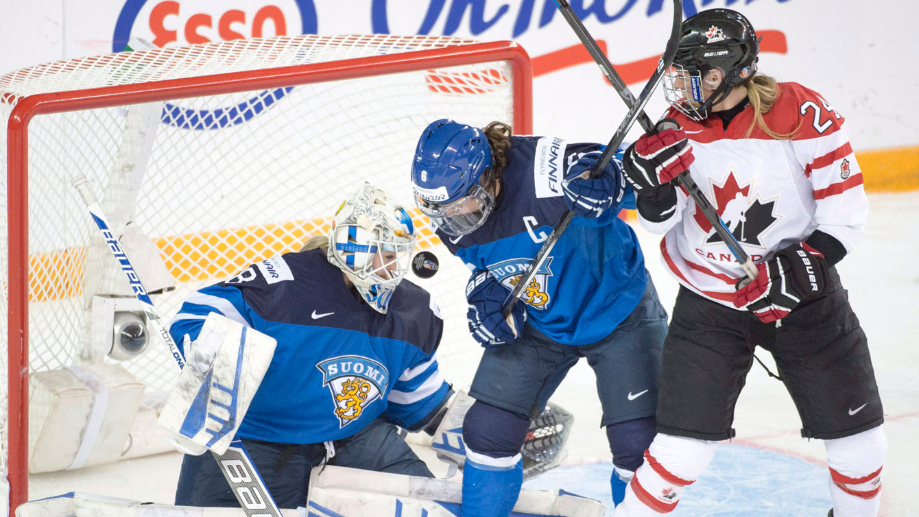 Natalie Spooner (right) scores the first Canadian goal of the game at the IIHF women's world championship semifinal against Finland on April 3, 2016.