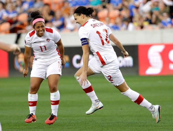 10806008_2 Canada's Christine Sinclair (12) celebrates after scoring a goal with Desiree Scott (11) against Costa Rica during the second half of a CONCACAF Olympic women's soccer qualifying championship semifinal Friday, Feb. 19, 2016, in Houston. Canada won 3-1. (AP Photo/David J. Phillip)