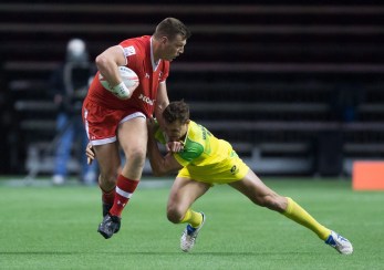 Canada's Adam Zaruba, left, fights off Australia's Stephan van der Walt during World Rugby Sevens Series' Canada Sevens tournament action, in Vancouver, B.C., on Saturday, March 12, 2016. THE CANADIAN PRESS/Darryl Dyck
