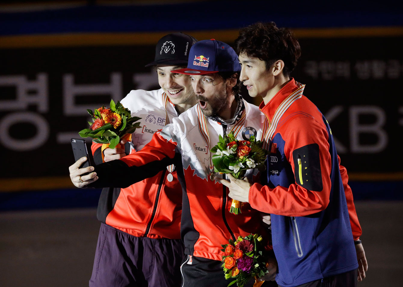 Hamelin poses for a selfie with the other medallists