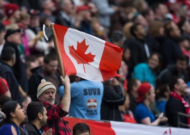 A spectator dressed as a lumberjack waves a Canadian flag as Canada and England play during World Rugby Sevens Series' Canada Sevens bowl semi-final action, in Vancouver, B.C., on Sunday March 13, 2016. THE CANADIAN PRESS/Darryl Dyck