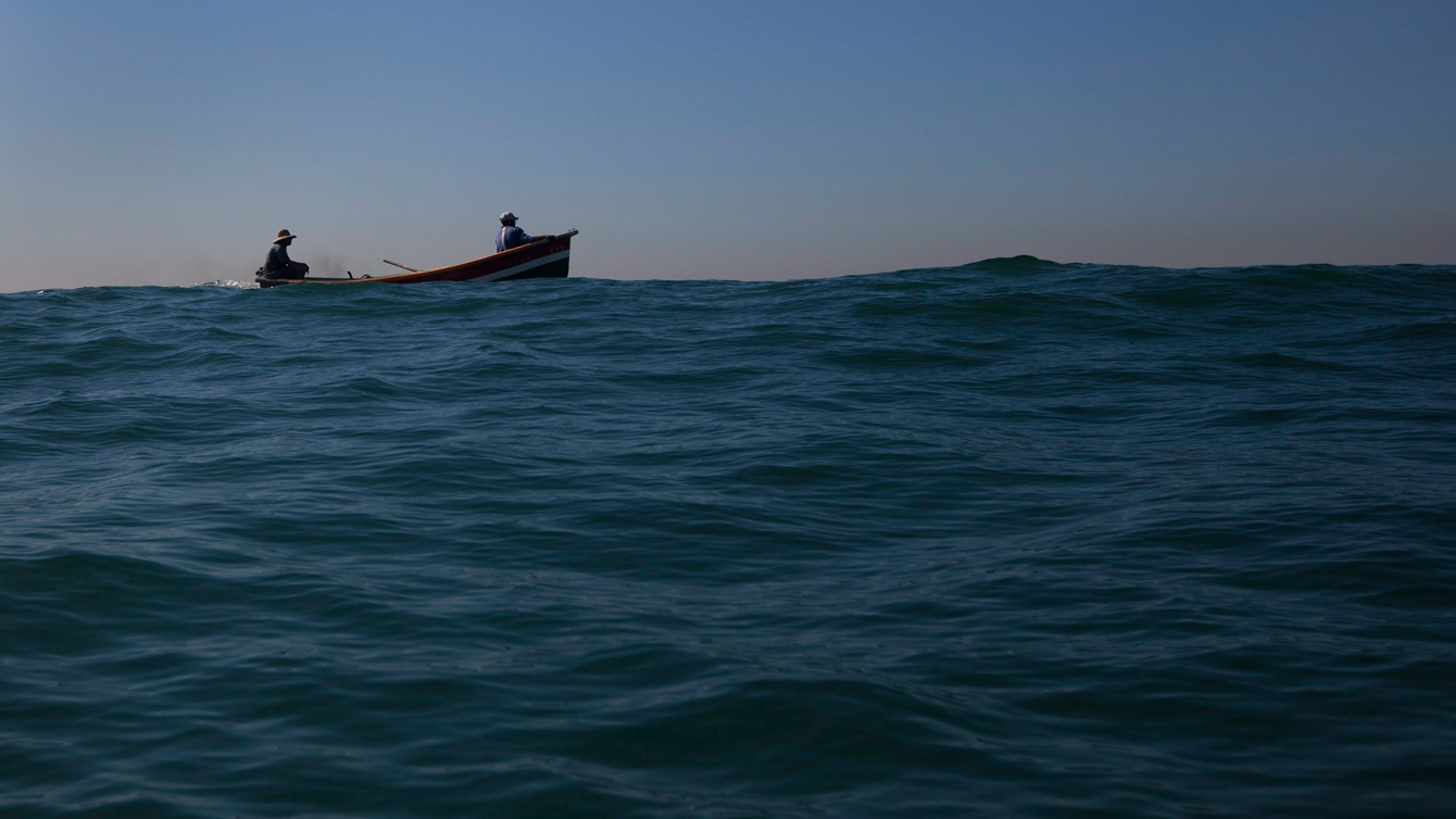 Fishermen from the Z-13 Colony fish on the waters off Copacabana beach. (Photo: AP/Felipe Dana)