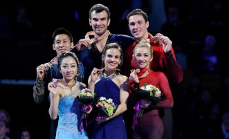 Silver medalists Wenjing Sui and Cong Han, left, of China, gold medalists Meagan Duhamel and Eric Radford, center, of Canada, and bronze medalists Aliona Savchenko and Bruno Massot, right, of Germany, pose with their medals during the awards ceremony for the pairs in the World Figure Skating Championships, Saturday, April 2, 2016, in Boston. (AP Photo/Elise Amendola)