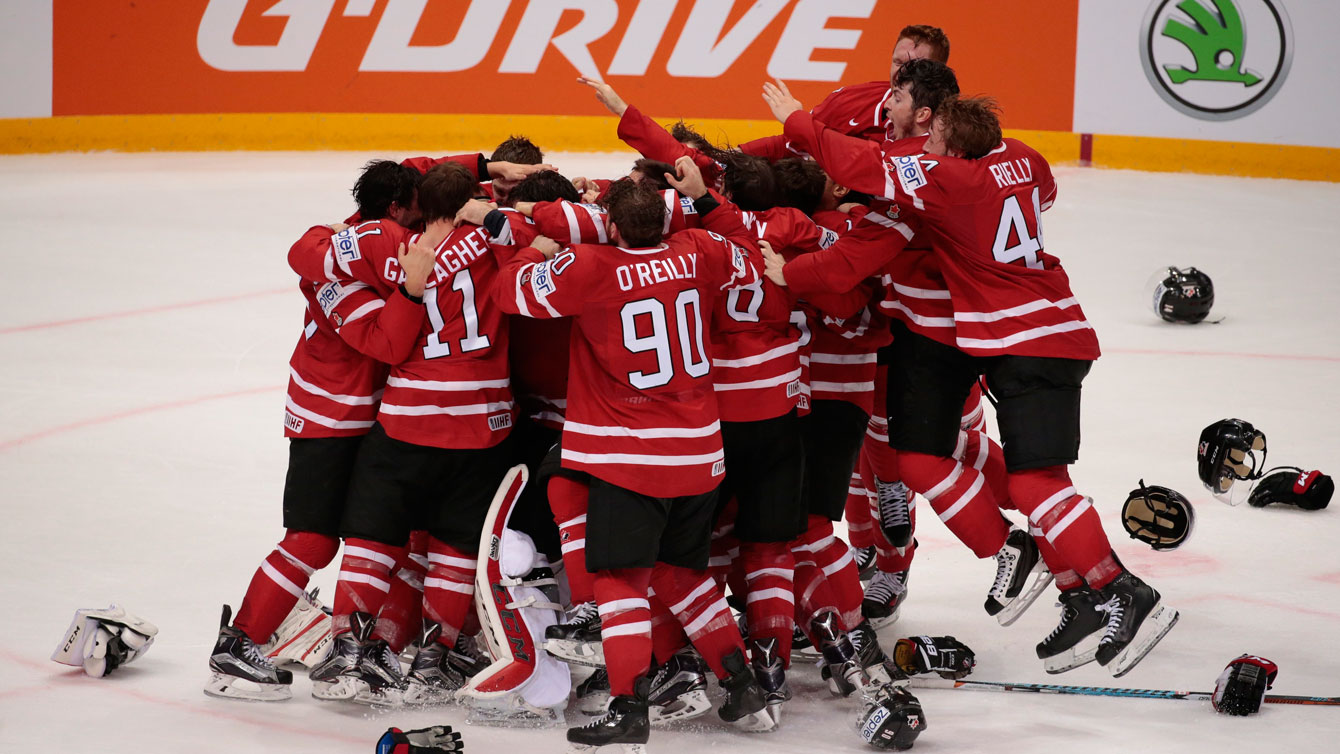 Canadian players celebrate winning gold at IIHF worlds final over Finland on May 22, 2016.