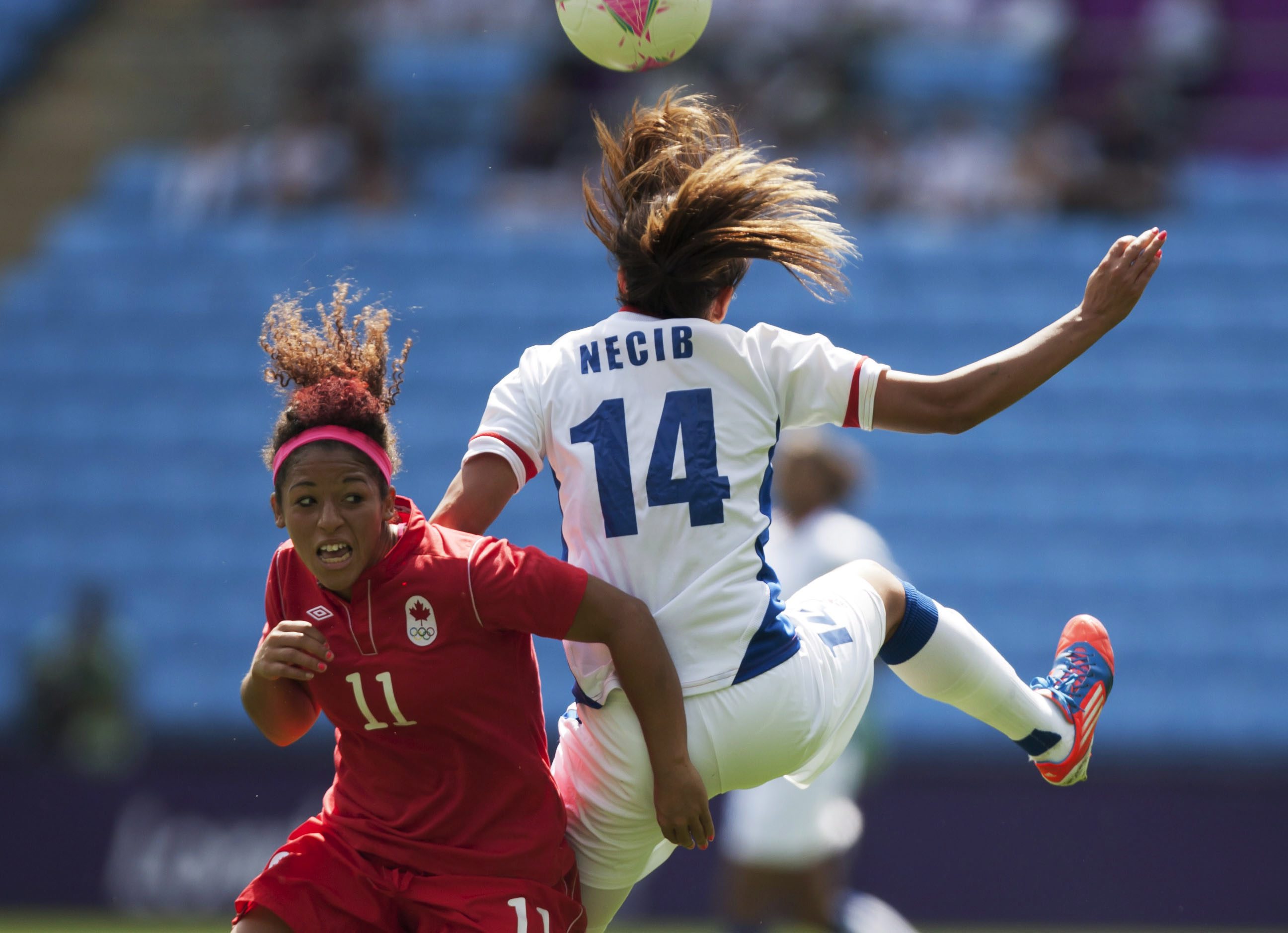 Canada's Desiree Scott, left, fights for the ball against Canada's Desiree Scott during their bronze medal women's soccer match at the 2012 London Summer Olympics, Thursday, Aug. 9, 2012 at the Ricoh Arena Stadium in Coventry, England. (AP Photo/Jon Super)
