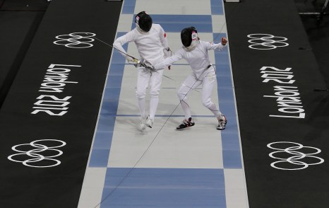 Canada's Donna Vakalis, right, competes against China's Chen Qian, left, during the fencing portion of the women's modern pentathlon competition at the 2012 Summer Olympics Sunday, Aug. 12, 2012, in London. (AP Photo/Hussein Malla)