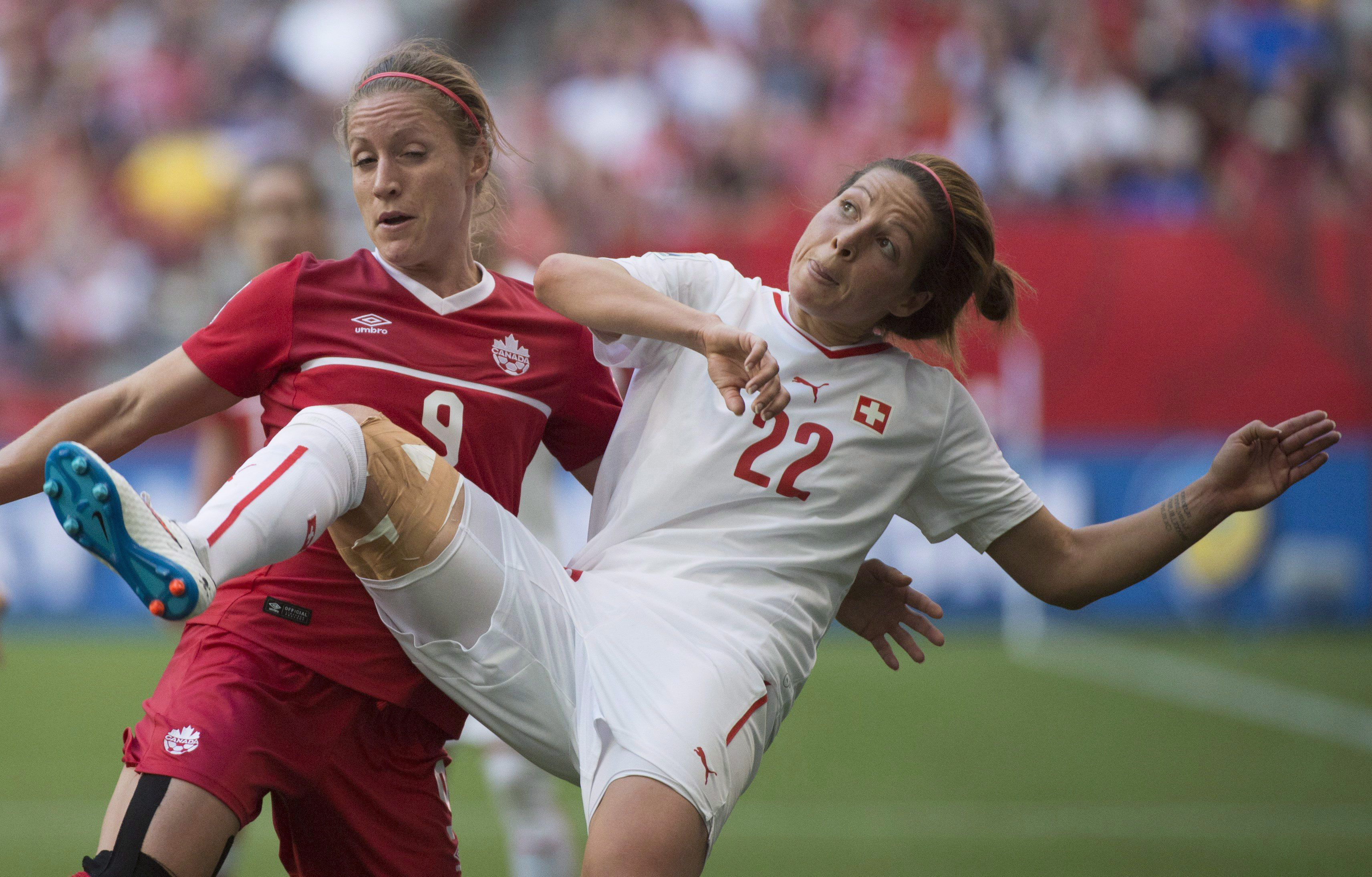 Switzerland's Vanessa Bernauer, right, fights for control of the ball with Canada's Josee Belanger during the second half of FIFA Women's World Cup round of 16 soccer action in Vancouver, B.C. Sunday, June 21, 2015. THE CANADIAN PRESS/Jonathan Hayward