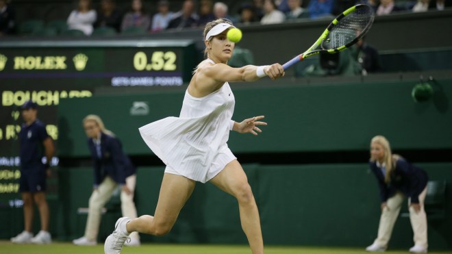 Eugenie Bouchard of Canada plays a return to Magdalena Rybarikova of Slovakia during their women's singles match on day three of the Wimbledon Tennis Championships in London, Wednesday, June 29, 2016. (AP Photo/Tim Ireland)