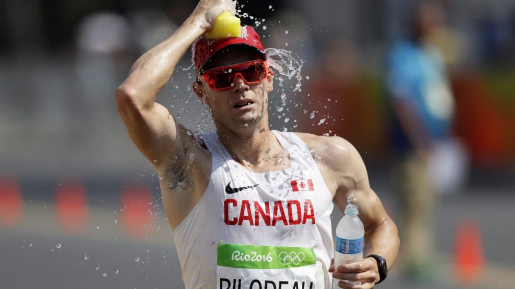 Mathieu Bilodeau running while pouring water on head