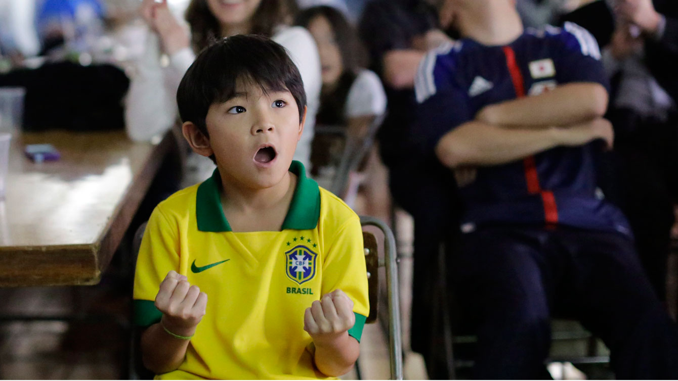 A young Brazilian soccer fan reacts as he watches the opening Confederations Cup soccer match between Brazil and Japan at a community center in the Liberdade neighborhood or Japantown, in Sao Paulo, Brazil, Saturday, June 15, 2013. 