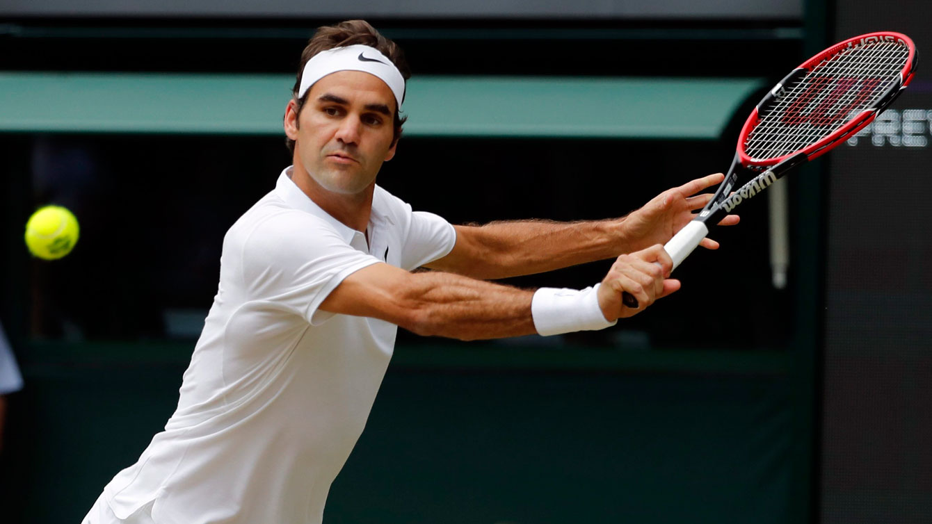 Roger Federer reaches for a backhand return against Milos Raonic at their Wimbledon semifinal on July 8, 2016. 