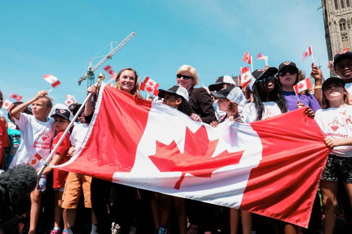 Rosie MacLennan holding the Canadian Flag after being named Canada's flag bearer for Rio 2016. July 21, 2016 in Ottawa. (Thomas Skrlj/COC)