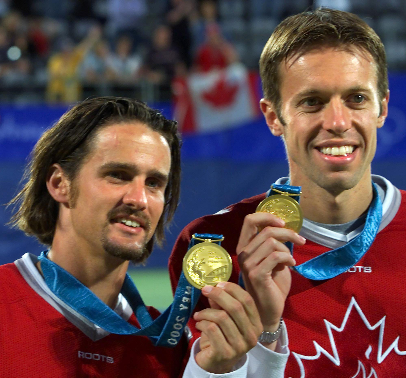 Sebastien Lareau (left) and Daniel Nestor of Canada hold up their gold medals after winning them in men's doubles tennis at the Olympic Games in Sydney Australia Wednesday Sept 27, 2000. (CP PHOTO/Tom Hanson)