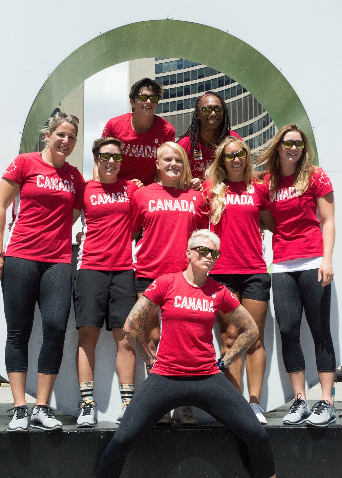 Some members of the rugby team posing in front of the "Toronto" sign at Nathan Phillips Square on July 26, 2016. (Tavia Bakowski/COC)