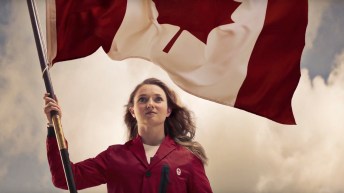 Rosie MacLennan posing with the Canadian flag