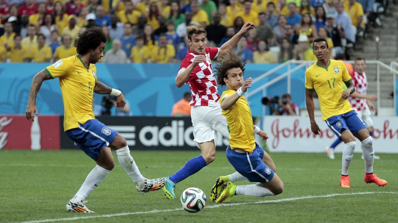 In this June 12, 2014 file photo, Brazil's Marcelo, left, tries to clear the ball but scores on his own goal during the group A World Cup soccer match between Brazil and Croatia, the opening game of the tournament, in the Itaquerao Stadium in Sao Paulo, Brazil. Marcelo looked wide-eyed stunned when he scored the first goal of the World Cup ... against his own team. Hardly the most auspicious of starts for Brazil. But that blooper just 11 minutes in was soon forgiven and forgotten as Brazil went on to win that opening game and the 2014 tournament quickly flowered into a rip-roaring success, confounding doom and gloom merchants who predicted Brazil couldnt pull it off without major protests and problems. (AP Photo/Ivan Sekretarev, File)