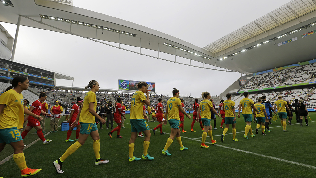 Australia, front row, and Canada team soccer players enter the field before their 2016 Summer Olympics football match at the Arena Corinthians in Sao Paulo, Brazil, Wednesday, Aug. 3, 2016. (AP Photo/Nelson Antoine)