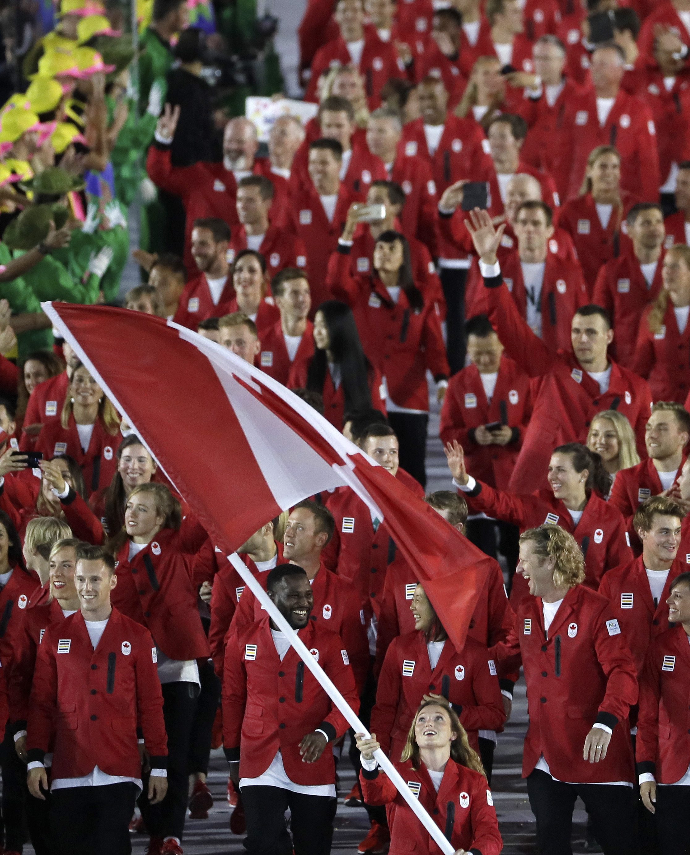 Rosannagh Maclennan carries the flag of Canada during the opening ceremony for the 2016 Summer Olympics in Rio de Janeiro, Brazil, Friday, Aug. 5, 2016. (AP Photo/Matt Slocum)