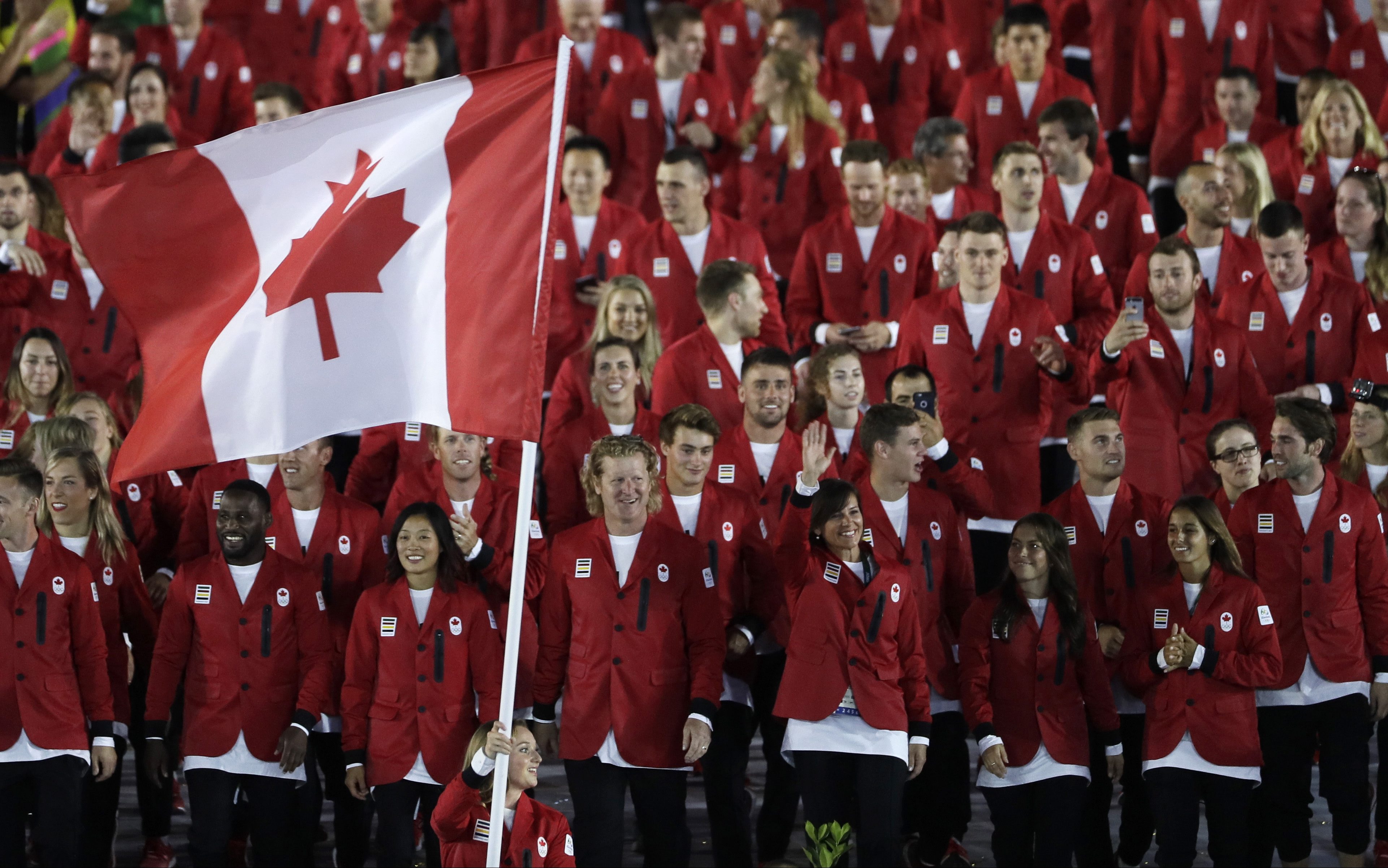 Rosannagh Maclennan carries the flag of Canada during the opening ceremony for the 2016 Summer Olympics in Rio de Janeiro, Brazil, Friday, Aug. 5, 2016. (AP Photo/Matt Slocum)