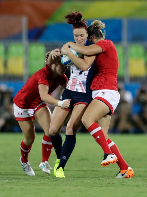 Rio 2016: Rugby Women Great Britain's Joanne Watmore, middle, is tackled by Canada's Kayla Moleschi, left, and teammate Kelly Russell, during the women's rugby sevens bronze medal match at the Summer Olympics in Rio de Janeiro, Brazil, Monday, Aug. 8, 2016. (AP Photo/Themba Hadebe)