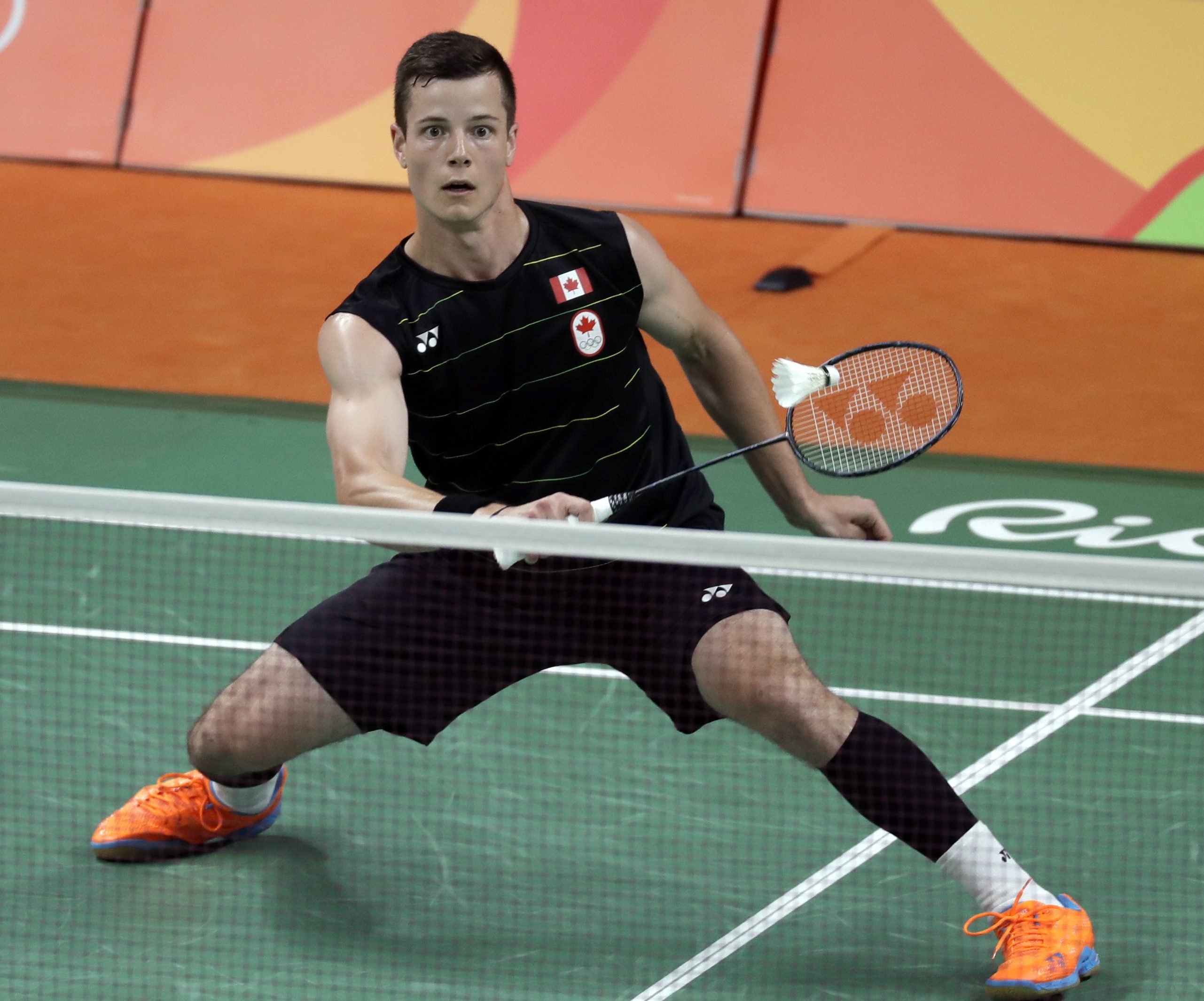 Canada's Martin Giuffre returns a shot to Hong Kong's Ng Ka Long Angus during a men's badminton match at the 2016 Summer Olympics in Rio de Janeiro, Brazil, Thursday, Aug. 11, 2016. (AP Photo/Kin Cheung)