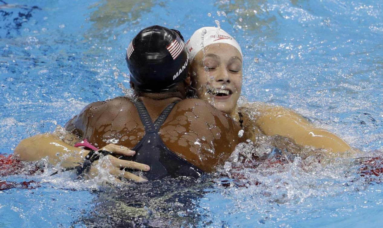 United States' Simone Manuel, left, and Canada's Penny Oleksiak celebrate winning joint gold and setting a new olympic record in the women's 100-meter freestyle during the swimming competitions at the 2016 Summer Olympics, Thursday, Aug. 11, 2016, in Rio de Janeiro, Brazil. (AP Photo/Natacha Pisarenko)